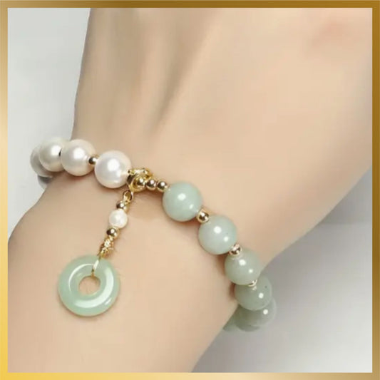 a beautiful half pearl half artificial jade with a charm elastic bracelet look so elegant.