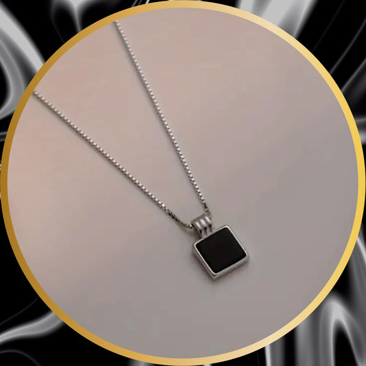 a stainless steel necklace with a black square stone pendant.