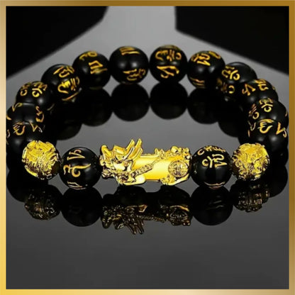 black lucky wealth and fortune Pixiu beads bracelet with a gold plated dragon and it's a stretchable elastic band with a 2.41 inches diameter.