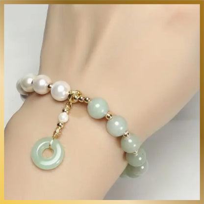 a beautiful half pearl half artificial jade with a charm elastic bracelet look so elegant.